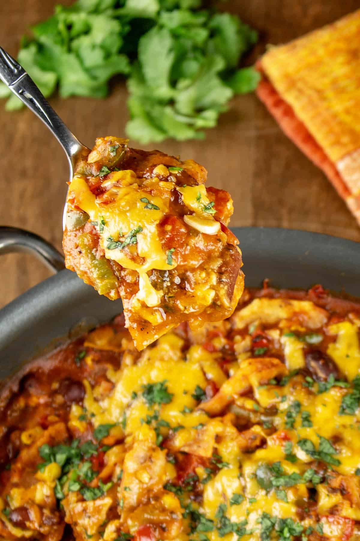 A spoonful of Meatless Enchilada Casserole taken from the pot