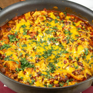 A dish of Vegetarian Enchilada Casserole served hot from the oven, garnished with chopped cilantro