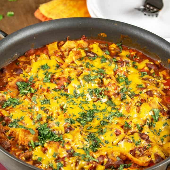 Meatless Enchilada Casserole served in a dish hot from the oven, garnished with chopped cilantro