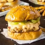 A grilled ground pork slider topped with spicy guajillo mayo and pickled jalapenos