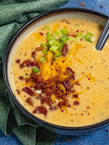 Like a baked potato in a bowl, creamy potato soup garnished with crumbled bacon, chives, and shredded cheddar cheese