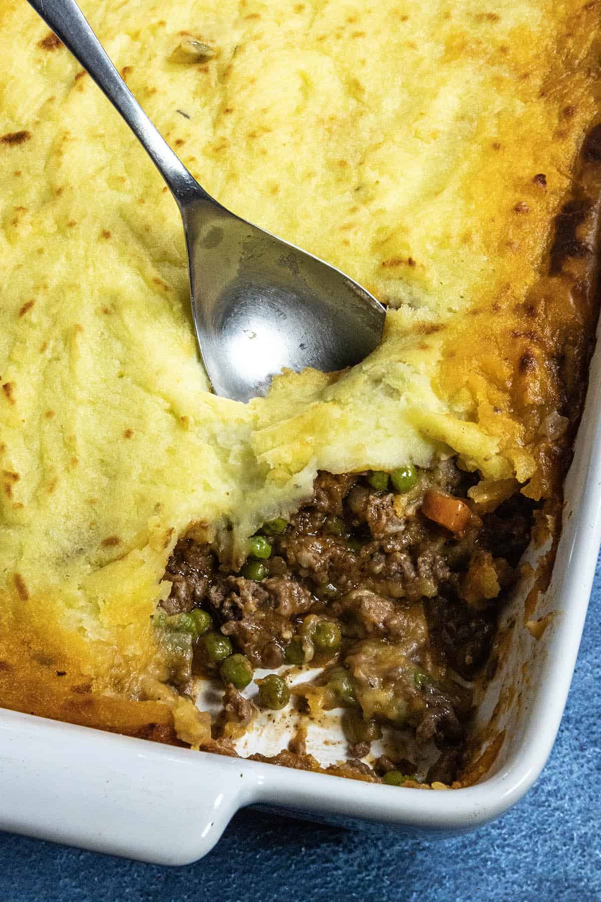 Shepherds Pie being scooped from the baking dish
