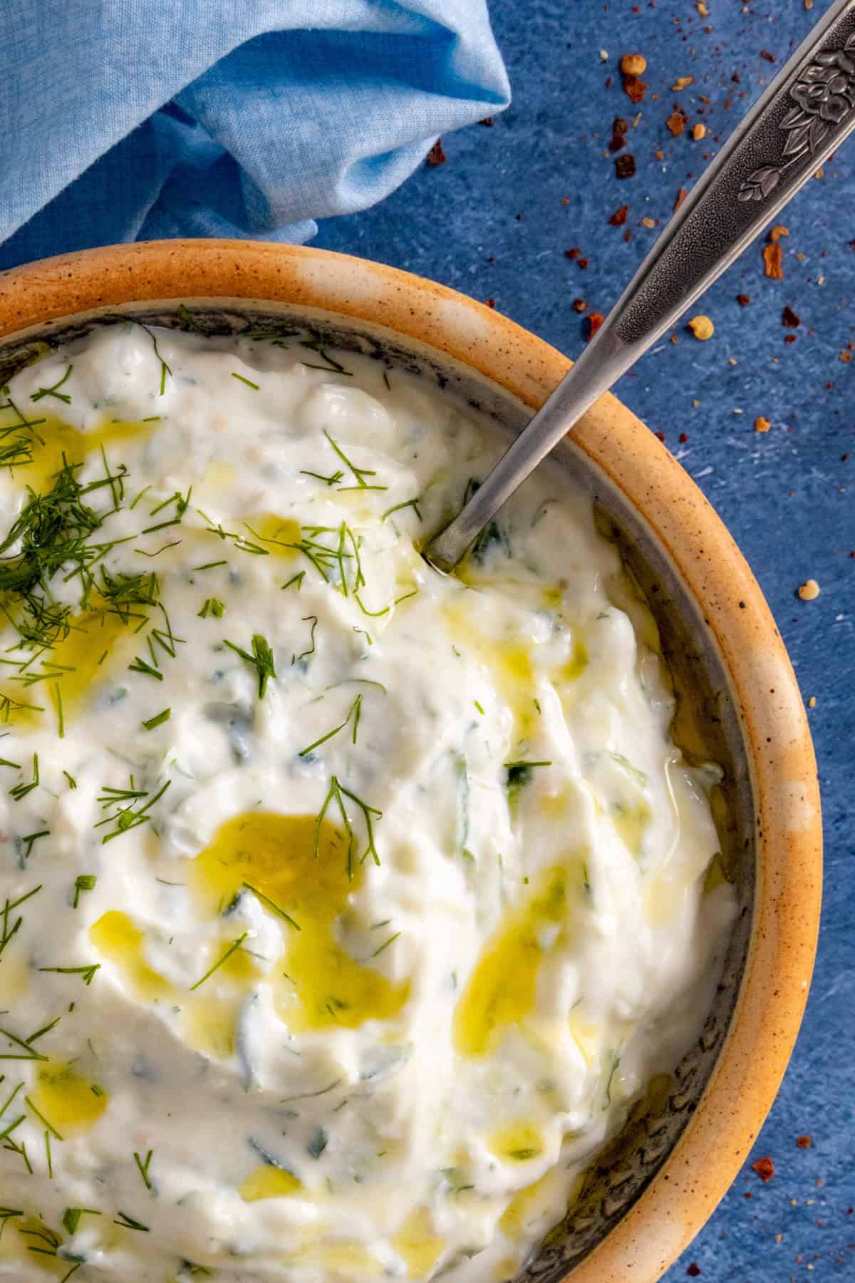 Homemade Tzatziki Sauce in a bowl drizzled with olive oil