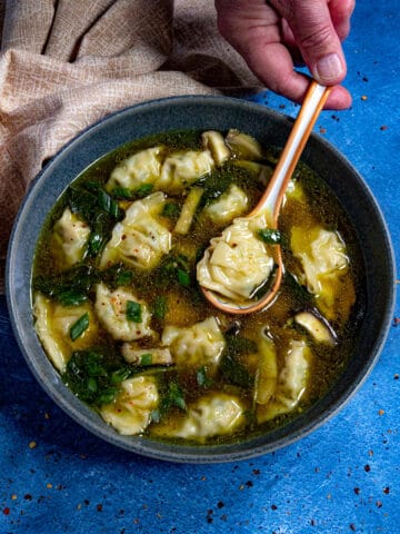Easy Wonton Soup in a bowl, ready to serve, garnished with chopped green onion