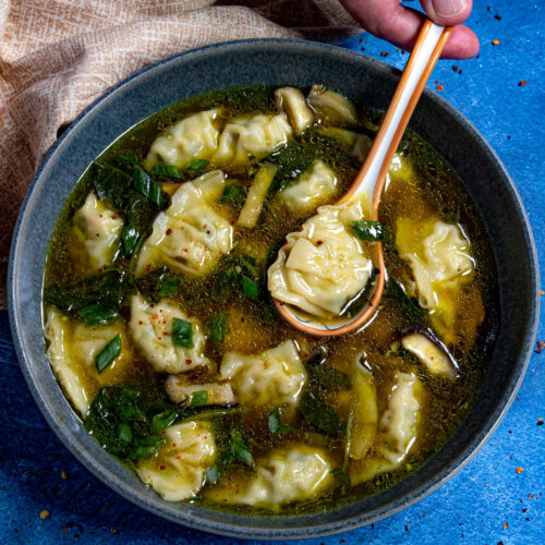 Easy Wonton Soup in a bowl, ready to serve, garnished with chopped green onion