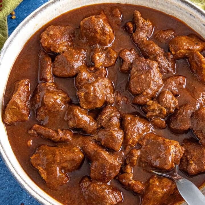 A saucy bowl filled with Mexican pork stew (asado de puerco)