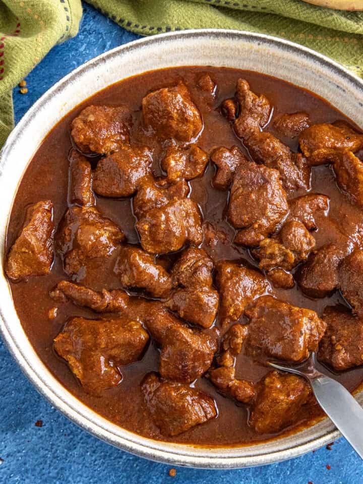A saucy bowl filled with Mexican pork stew (asado de puerco)