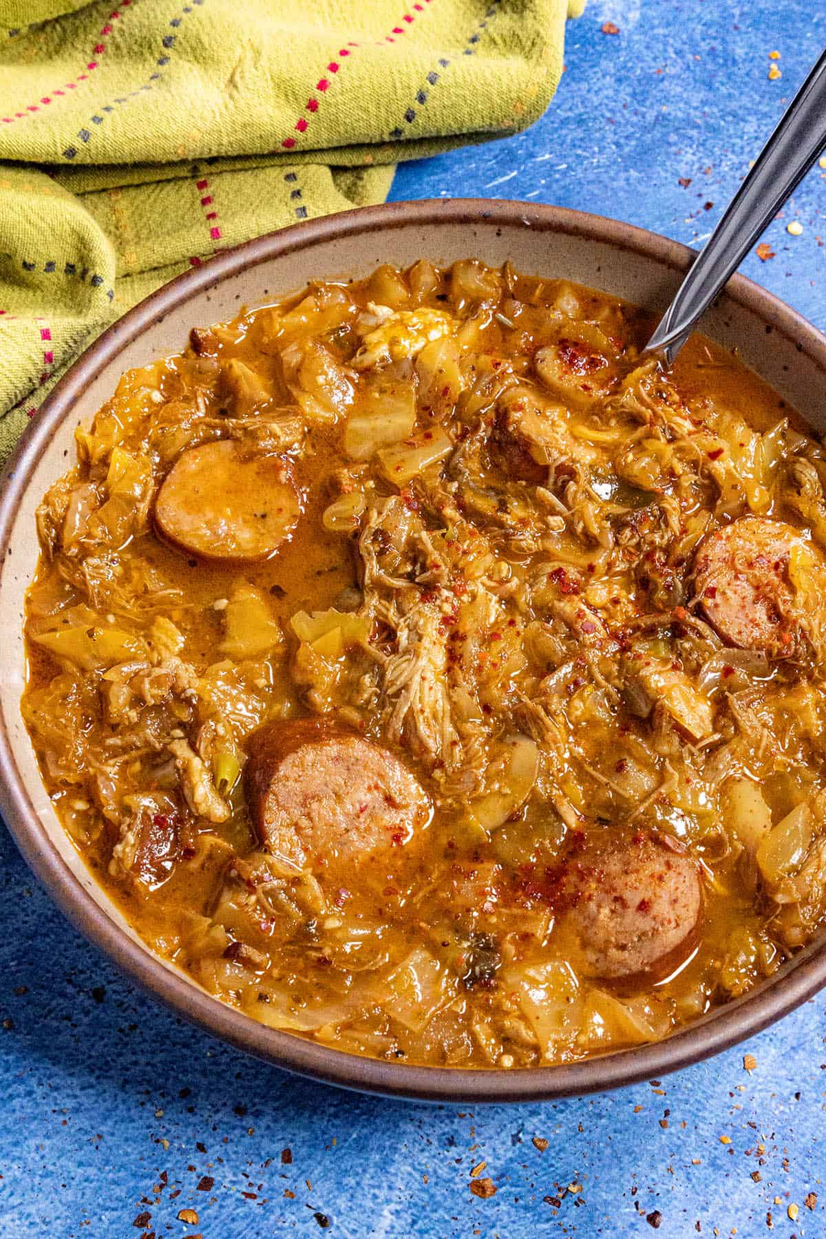 A large bowl of Bigos (Polish Hunter's Stew), garnished with chili flakes
