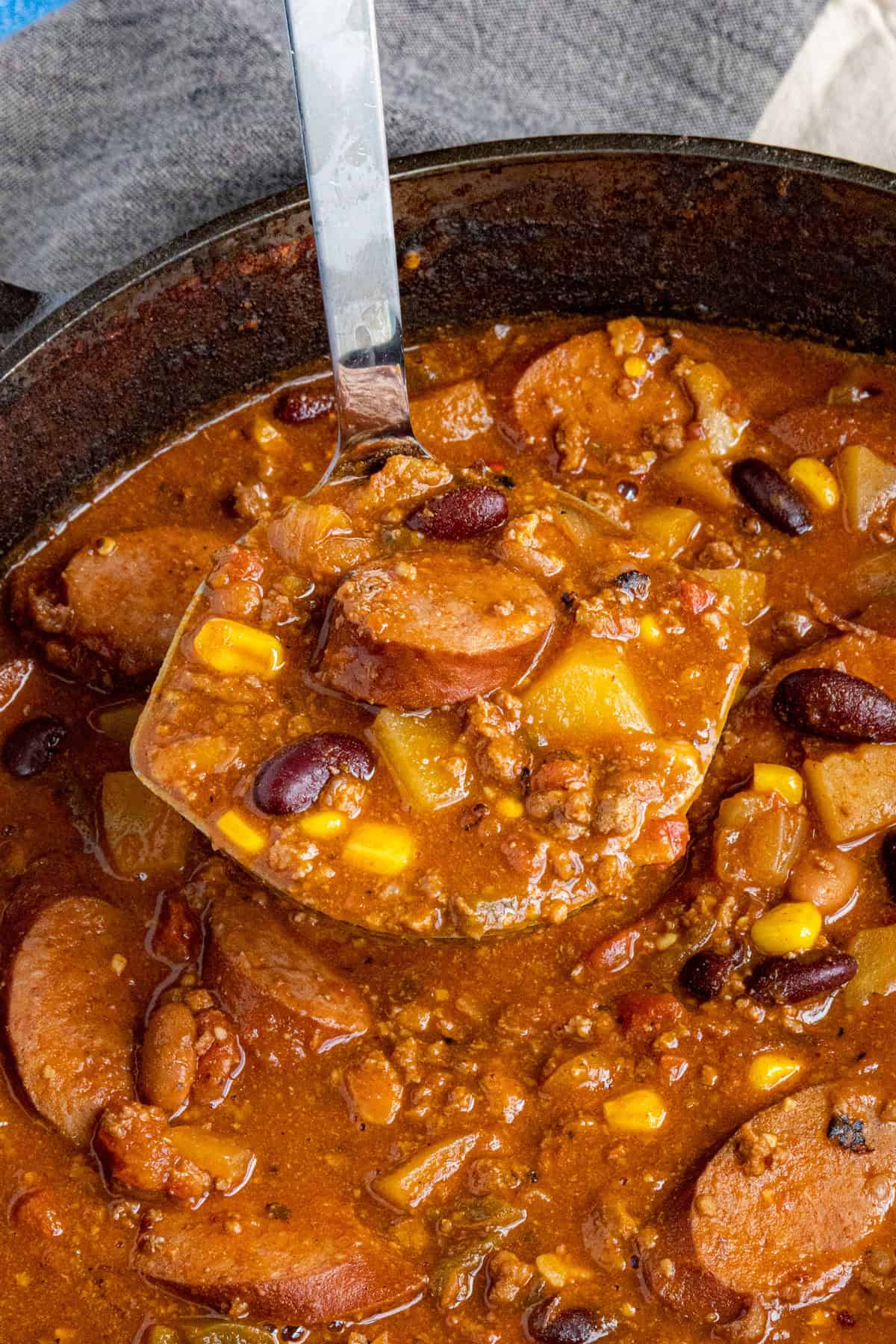 A big scoop of Chunky Cowboy Stew being served from the pot
