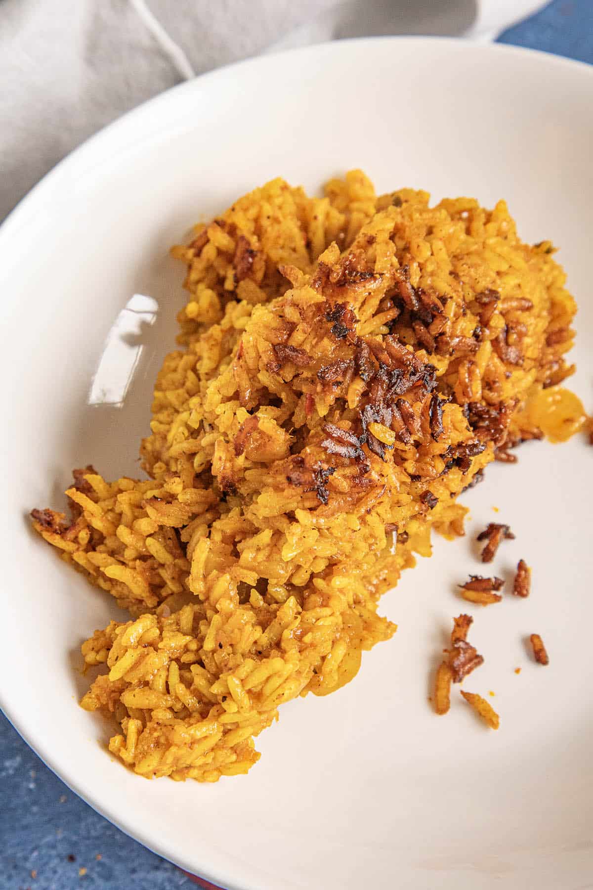 Jollof rice served on a plate with the crispy rice from the bottom of the pot
