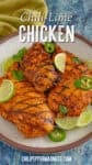 3 char grilled chili lime chicken breasts on the serving plate, garnished with lime slices, fresh sliced jalapenos, and fresh cilantro