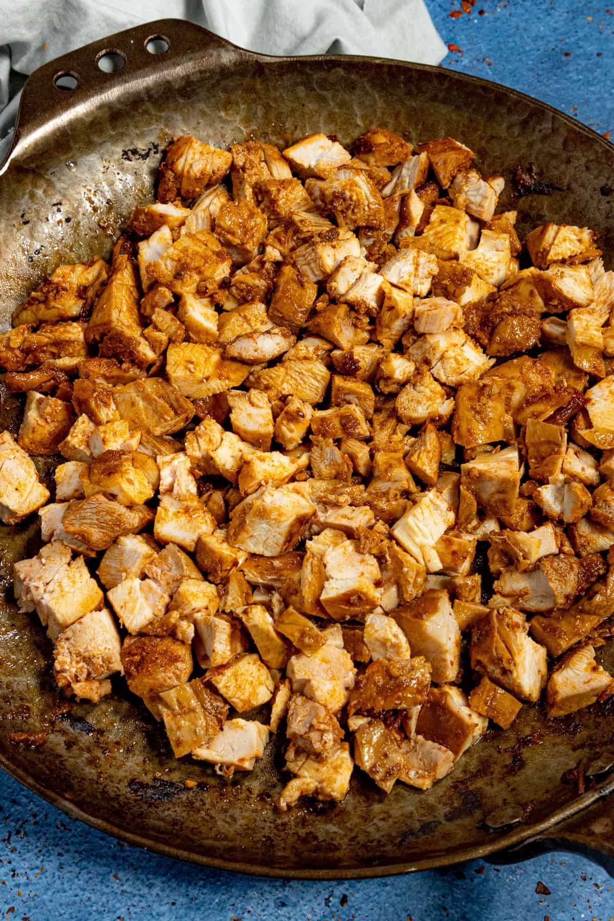 A pan filled with saucy pieces of chopped chipotle chicken