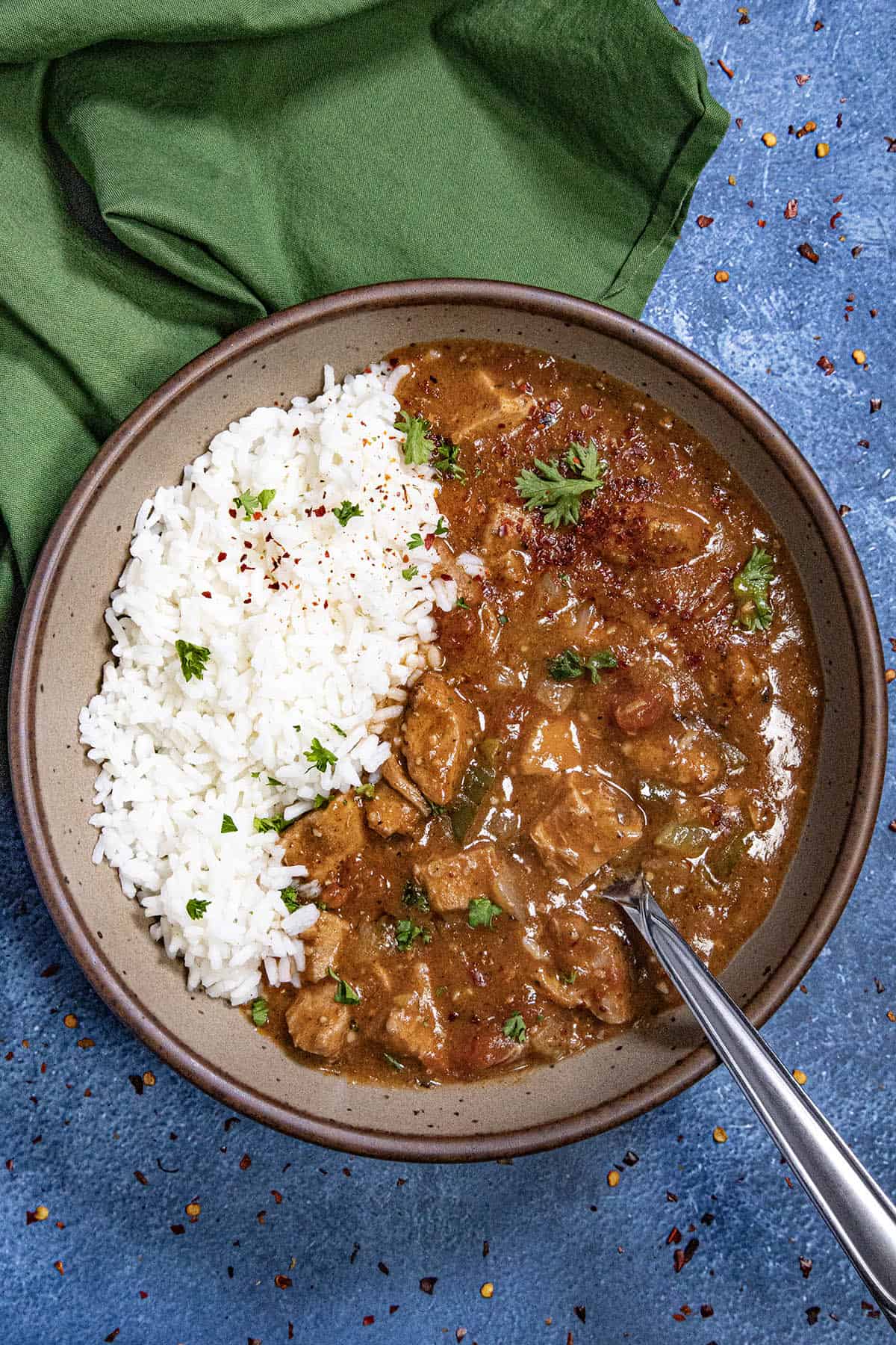 A bowl of rich chicken Sauce Piquante served in a bowl over white rice