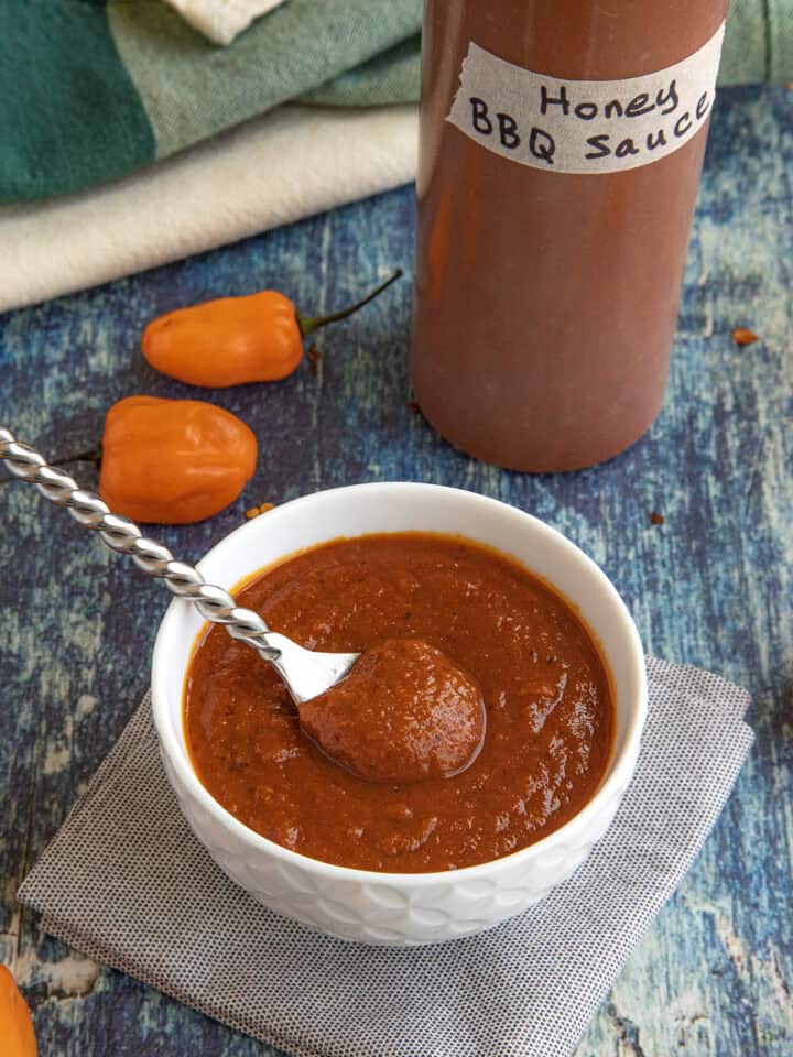 Spicy habanero honey bbq sauce served in a bowl, and in a squeeze bottle