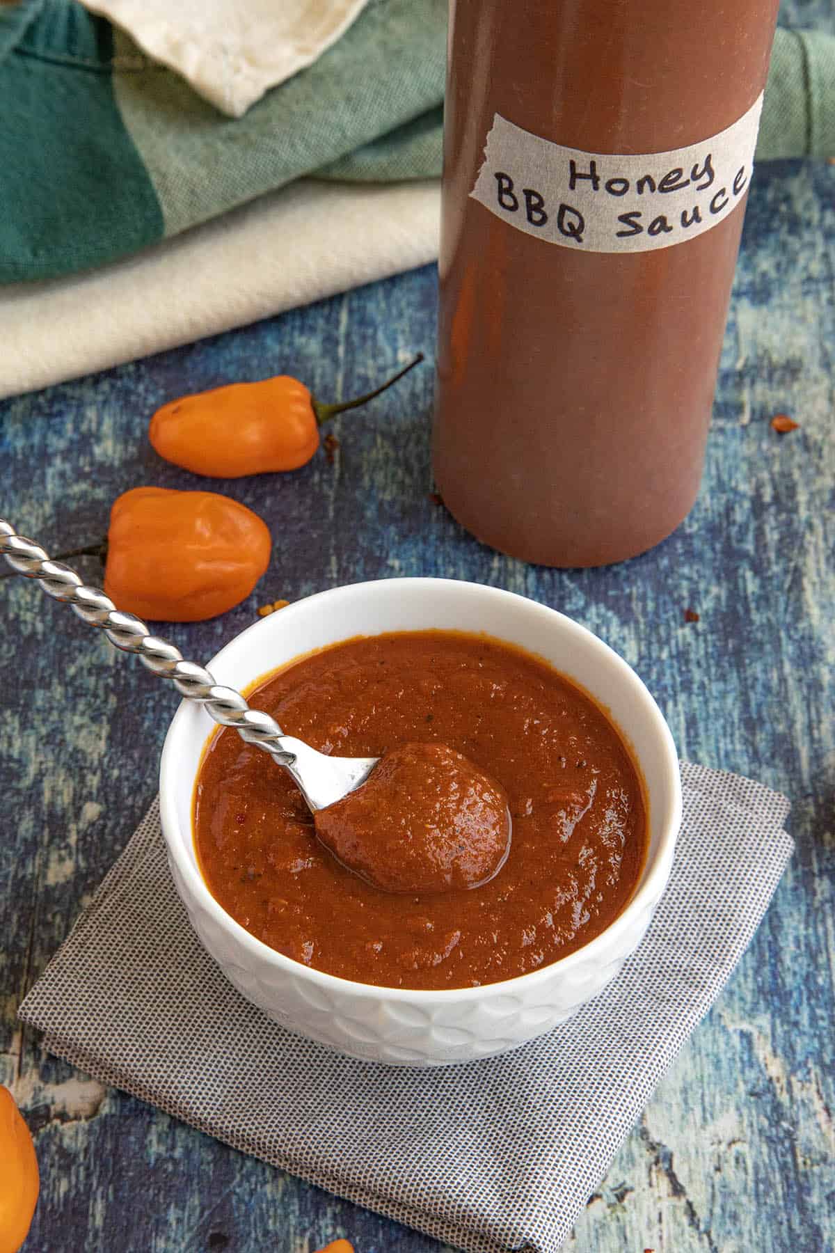 Spicy habanero honey bbq sauce served in a bowl, and in a squeeze bottle