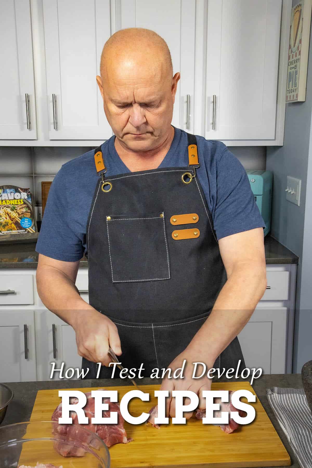 Mike from Chili Pepper Madness testing recipes in the kitchen, cutting meat on a cutting board