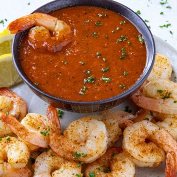 Zesty cocktail sauce served in a bowl with spicy seared shrimp
