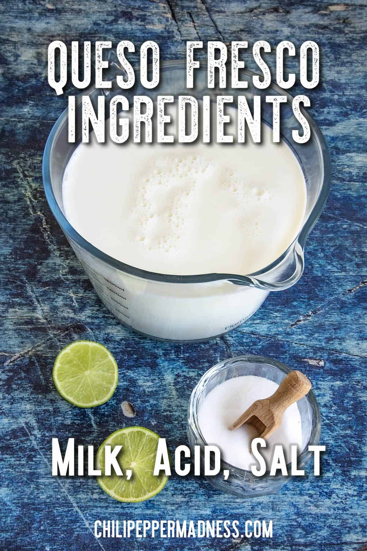 A measuring cup of milk, half a lime, and a small bowl of salt with a wooden scoop on a blue surface. Text over the image reads: Queso Fresco Ingredients—perfect to make your own fresh Queso Fresco at home: Milk, Acid, Salt.