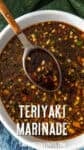 A bowl of the best Teriyaki Marinade mixed with chopped herbs and chili flakes, stirred with a wooden spoon. Text on the image reads Teriyaki Marinade and chilipeppermadness.com.