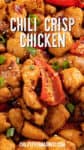 Close-up of easy chili crisp chicken recipe featuring succulent chicken pieces cooked with red peppers, garnished with chopped green onions and sesame seeds. Text overlay reads Chili Crisp Chicken and chilipeppermadness.com.