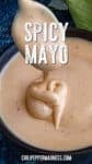 A spoon holds creamy, light orange Spicy Mayo sauce above a bowl, with SPICY MAYO written on the image and chilipeppermadness.com at the bottom.