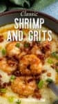 A bowl of creamy grits topped with seasoned shrimp, crumbled bacon, chopped green onions, and a drizzle of sauce—a Classic Shrimp and Grits Recipe.