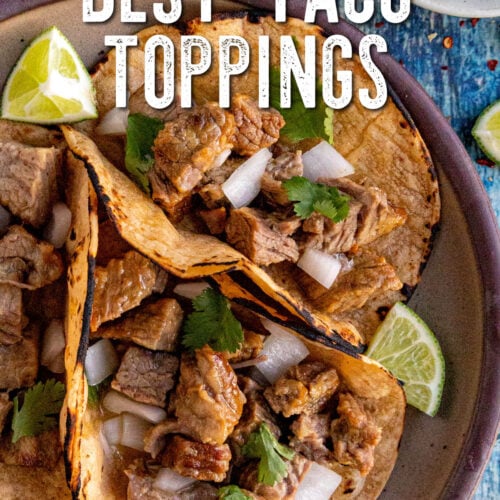 Three corn tortillas filled with chopped grilled meat, diced onions, and cilantro, served with lime wedges on a plate. Sliced jalapeños are visible in the background, highlighting some of the Best Taco Toppings. Text reads “Best Taco Toppings.”.