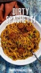 A bowl of Dirty Spaghetti topped with sliced sausage, ground meat, green onions, and spices. A fork rests in the bowl beside a brown napkin. Text over the image reads Dirty Spaghetti.