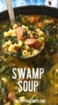 A ladle lifts a serving of hearty Swamp Soup (Turnip Green Soup) with sausage, beans, pasta, and greens from a pot. Text reads SWAMP SOUP.