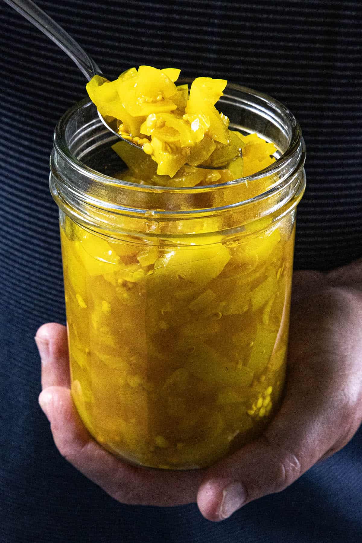 Mike from Chili Pepper Madness holding a jar of freshly made Banana Pepper Relish