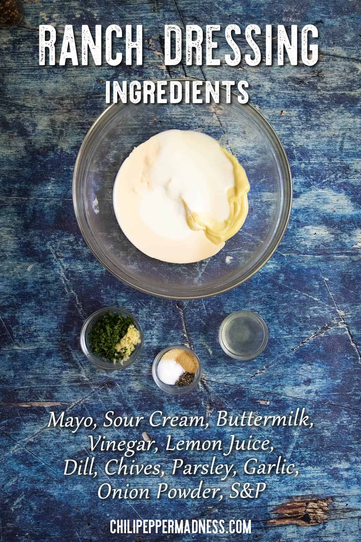 A bowl with mayo, sour cream, and buttermilk sits on a blue surface, surrounded by small bowls of herbs and spices—perfect for making Homemade Ranch Dressing. Text lists ranch dressing ingredients.