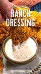 A hand dips a piece of crispy fried chicken into a bowl of Homemade Ranch Dressing, surrounded by more golden fried chicken pieces. Text over the image reads Homemade Ranch Dressing.