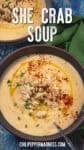 Creamy She Crab Soup in a bowl, topped with olive oil, chopped chives, red pepper flakes, and a small mound of crab meat.
