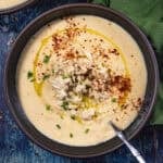 Charleston She Crab Soup with a drizzle of olive oil and paprika and a small mound of crab meat.