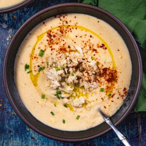 Charleston She Crab Soup with a drizzle of olive oil and paprika and a small mound of crab meat.