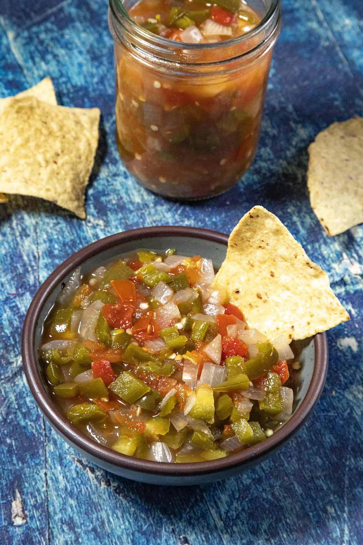 A bowl filled with salsa served with tortilla chips