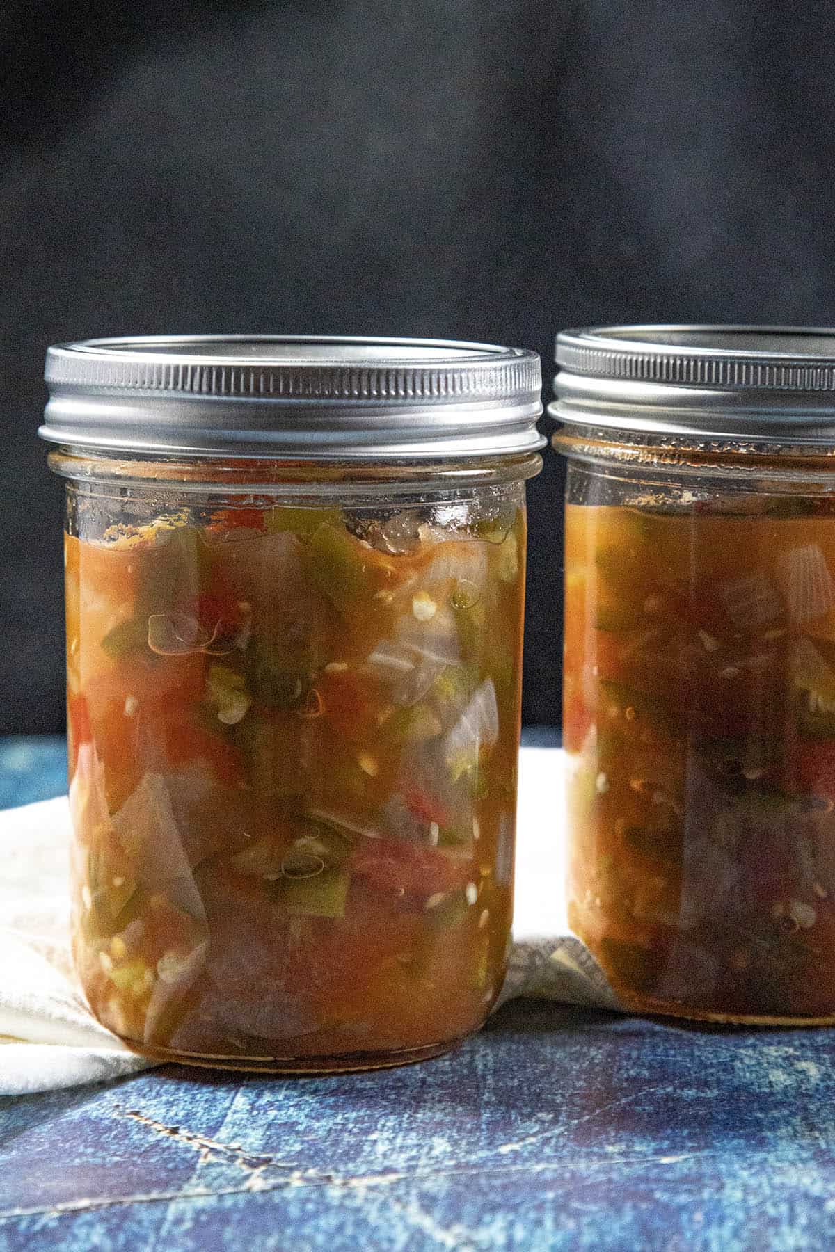 A jar of canned chunky salsa beside another jar