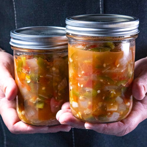 Mike from Chili Pepper Madness holding two jars of jarred salsa