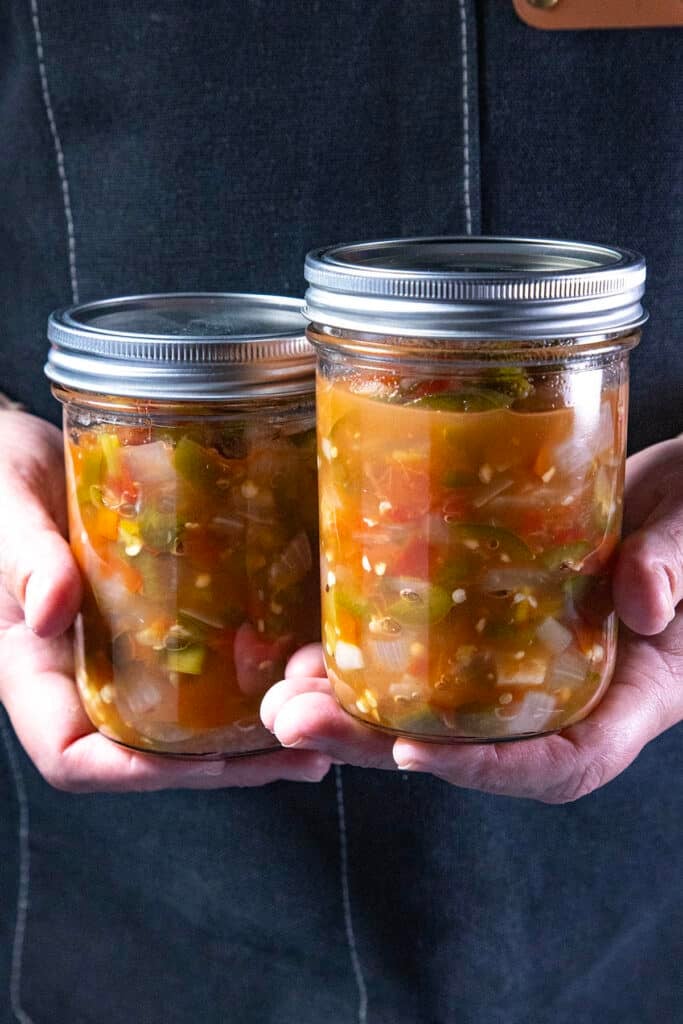 Mike from Chili Pepper Madness holding two jars of jarred salsa