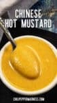 A small white bowl filled with creamy yellow Chinese Hot Mustard, with a spoon resting inside. Text above reads Chinese Hot Mustard, and the website chilipeppermadness.com is at the bottom.