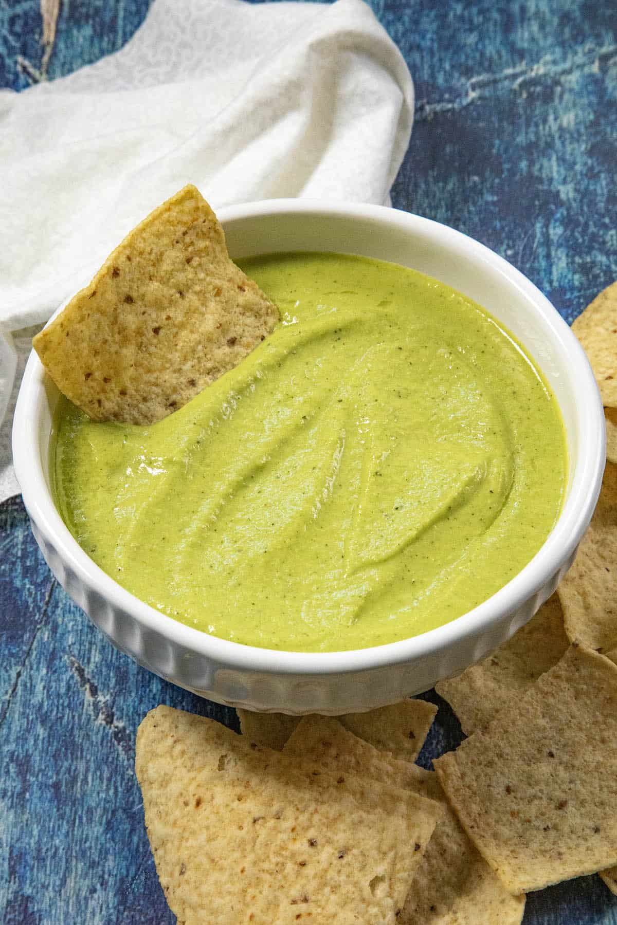 A bowl of creamy guacachile, taqueria salsa verde, with tortilla chips