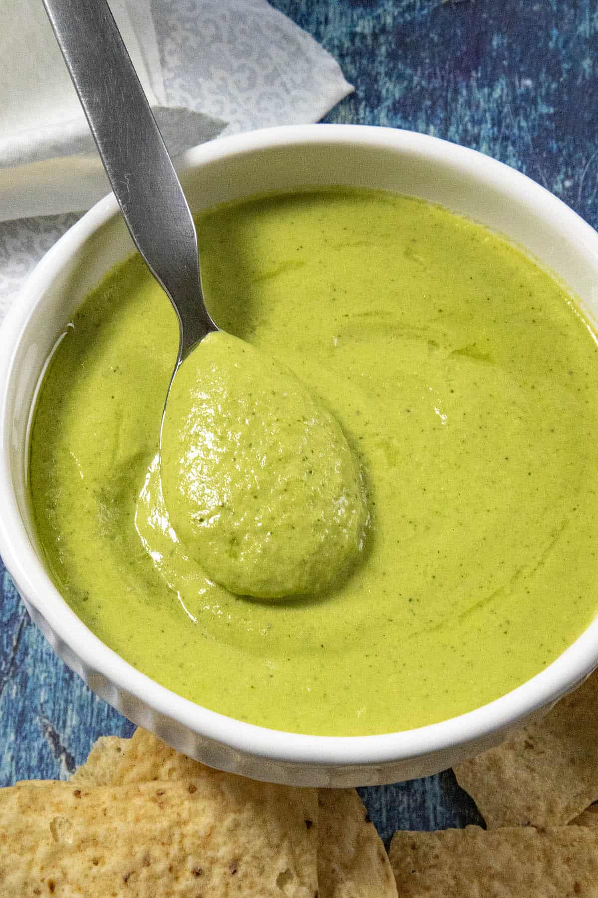 A bowl of creamy guacachile, taqueria salsa verde, with a spoon