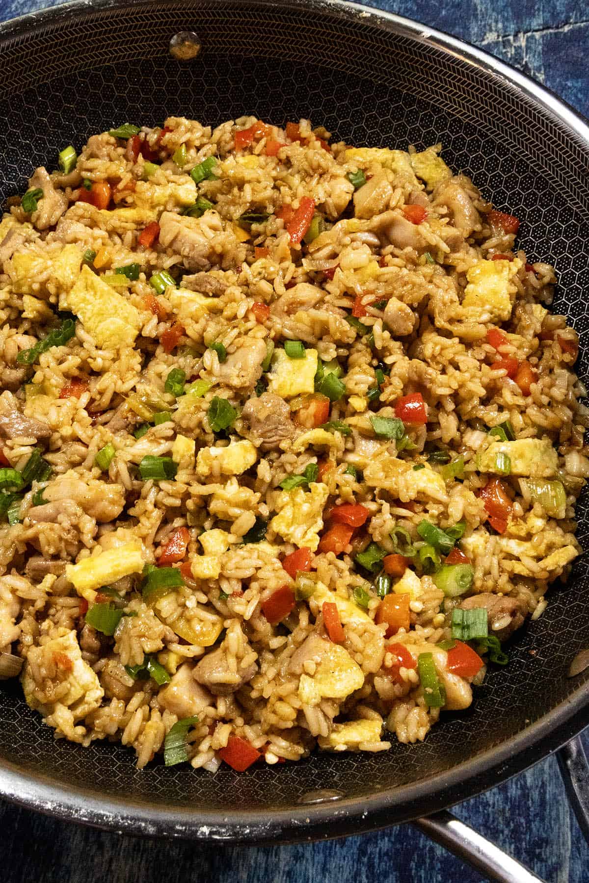 A large hot pan of freshly cooked Arroz Chaufa (Peruvian Fried Rice with Chicken), ready to be served