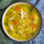 A bowl of golden Homemade Chicken Noodle Soup served with a spoon
