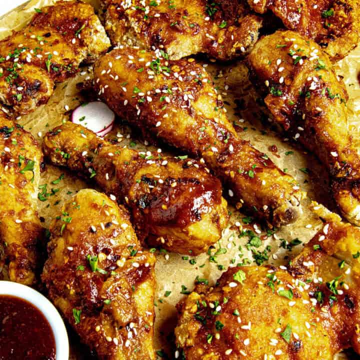 Crispy Korean Fried Chicken (Yangnyeom Chicken) on a serving platter with gochujang sauce